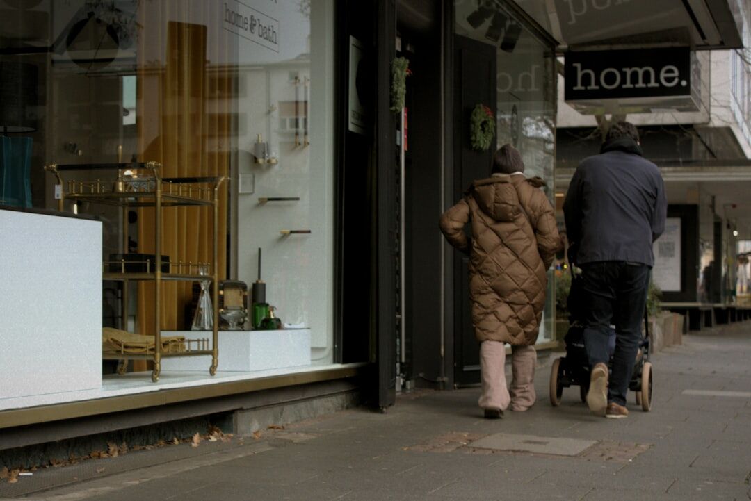 Senior couple looking at a discount offer in a small shop